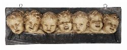 ELONGATED PLASTER WALL PLAQUE DEPICTING CHILDRENâ€™S FACES