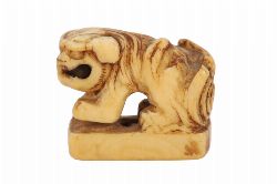 JAPANESE IVORY NETSUKE OF A SEATED FOO
