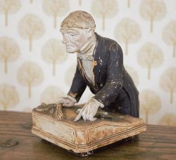 GLAZED POTTERY FIGURE OF A SCHOOL HEADMASTER