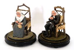 PAIR OF PRIMITIVE FIGURES OF SEATED ELDERLY MAN AND WOMAN