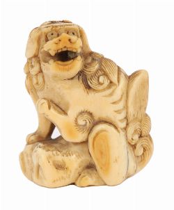 JAPANESE IVORY NETSUKE OF A MYTHICAL BEAST