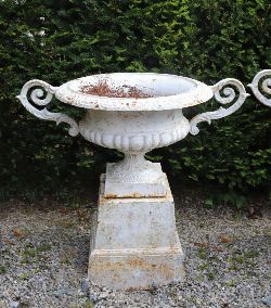 PAIR 19TH-CENTURY LARGE WHITE-PAINTED CAST IRON URNS ON PLINTHS