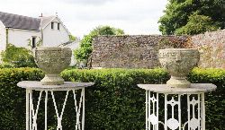 PAIR OF WEATHERED PATINATED COMPOSITE STONE CAMPANA URNS