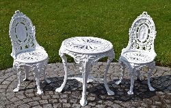 CAST-IRON GARDEN TABLE AND PAIR OF CHAIRS, IN THE COALBROOKDALE MANNER