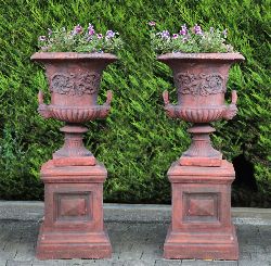 PAIR OF LARGE TERRACOTTA CAMPANA-FORM GARDEN URNS ON PEDESTALS