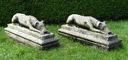 PAIR OF CARVED MOULDED STONE RECUMBENT HOUNDS