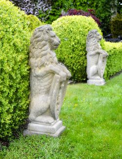 PAIR OF CARVED MOULDED STONE ARMORIAL LIONS