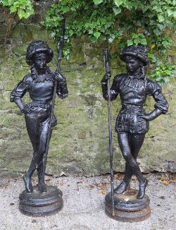 PAIR OF CAST IRON FRENCH SOLDIERS ON CIRCULAR PLINTHS
