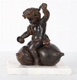 19TH-CENTURY CHARMING BRONZED FIGURE OF A PUTTO ON POMEGRANATES
