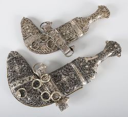 PAIR OF MIDDLE EASTERN SILVER-HILTED KHANJARS (JAMBIYAS)