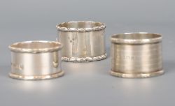 GROUP OF THREE STERLING SILVER NAPKIN RINGS