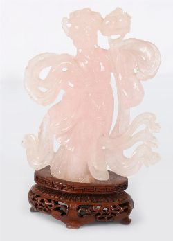 CARVED ROSE QUARTZ FIGURE OF GUANYIN ON HARDWOOD STAND