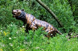 BRONZE LIFESIZE SCULPTURE OF A TIGER ON TREE STUMP