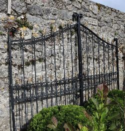 PAIR OF WROUGHT IRON GATES WITH FLEUR-DE-LIS FINIALS