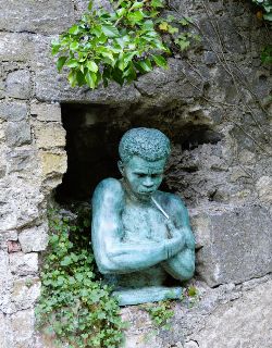 BRONZE SCULPTURE OF A MALE WITH FOLDED ARMS