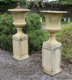 PAIR OF MOULDED STONE URNS