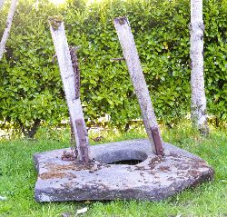 18TH-CENTURY STONE WELL HEAD WITH ORIGINAL IRON AND TIMBER MOUNTS