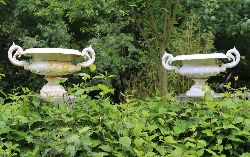PAIR OF CAST IRON GARDEN URNS EACH WITH SCROLL HANDLES