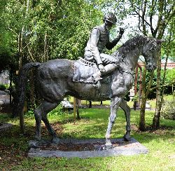MONUMENTAL BRONZE SCULPTURE OF A JOCKEY ON HORSEBACK