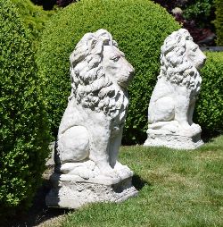 PAIR OF MOULDED STONE FIGURES OF SEATED LIONS