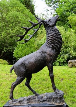 LIFESIZE STATUE OF ROARING STAG WITH RAISED HEAD ON NATURALISTIC BASE