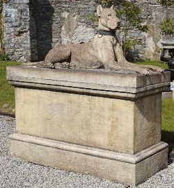 PAIR OF STONE SCULPTURES OF KINSALE HOUNDS ON RECTANGULAR BASES