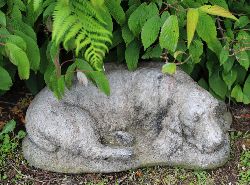 COMPOSITE STONE SCULPTURE OF A SLEEPING DOG