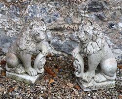 PAIR OF COMPOSITE STONE LIONS WITH SHIELDS