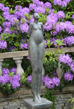 MOULDED STONE SCULPTURE OF A FEMALE ON SQUARE PLINTH