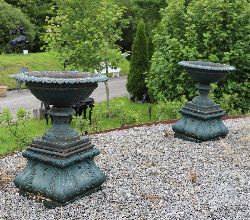 PAIR OF 19TH-CENTURY CAST IRON URNS ON ORIGINAL STANDS