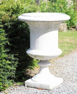 PAIR OF MOULDED STONE GEORGIAN STYLE GARDEN URNS ON SQUARE PLINTHS