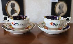 PAIR OF IRONSTONE TEACUPS AND SAUCERS WITH FLORAL MOTIF