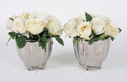 PAIR OF SILVERED PLANTERS WITH ARTIFICIAL ROSES